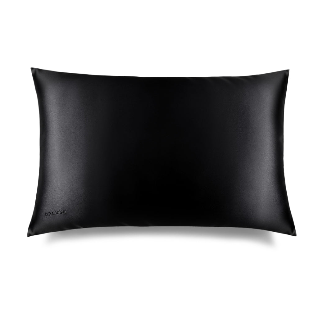 The Black Jade Silk Pillowcase by us.drowsysleepco is a rectangular black silk pillowcase with a smooth, shiny finish, shown on a white background. "DROWSY" is subtly embossed in the lower left—a beauty essential gentle on skin and hair.