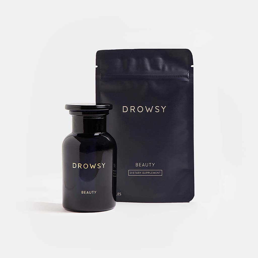 A black bottle and matching resealable pouch labeled Supplements - Beauty from us.drowsysleepco are displayed on a plain white background, created to support collagen synthesis and promote skin elasticity.