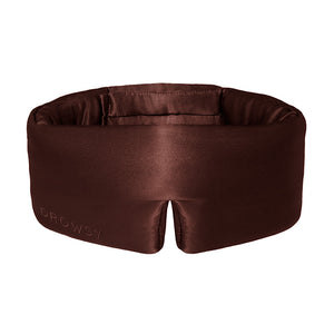 The Cocoa Glow by drowsysleepco is a brown, padded silk sleep mask embroidered with "Drowsy," designed to fully block out light and offer comfort around your eyes and head.