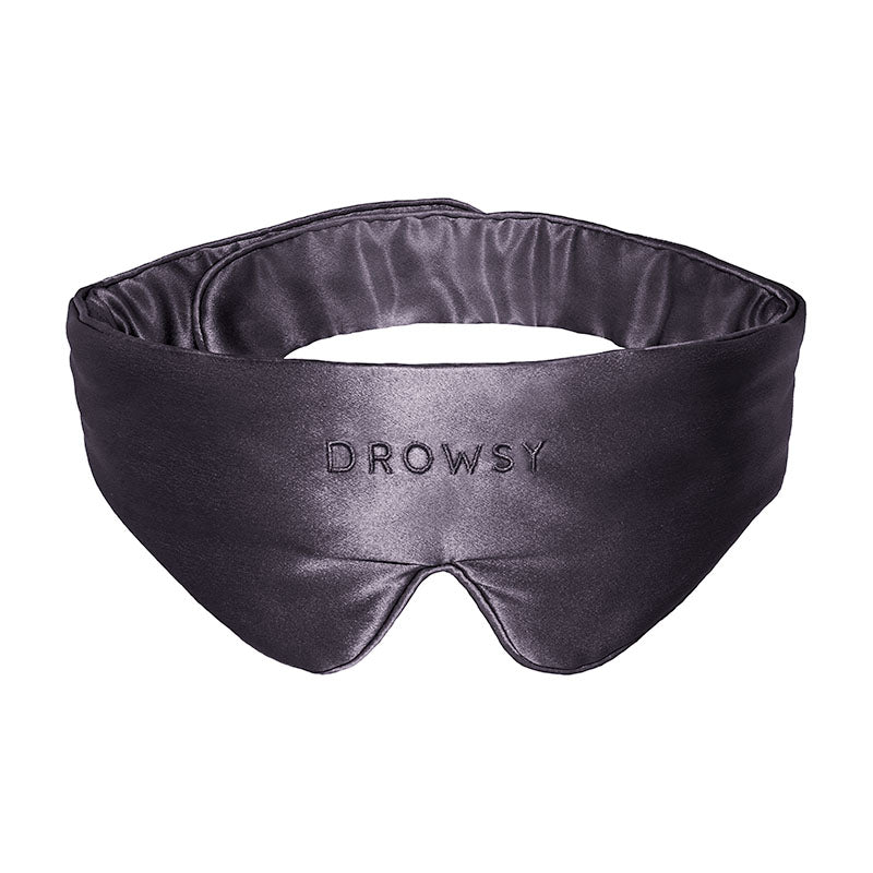 Introducing the Featherweight Silk Eye Mask Moonlight Shadow by us.drowsysleepco—a black eye mask crafted from luxurious mulberry silk, contoured for enhanced comfort and embroidered with "DROWSY" in bold capital letters on the front.