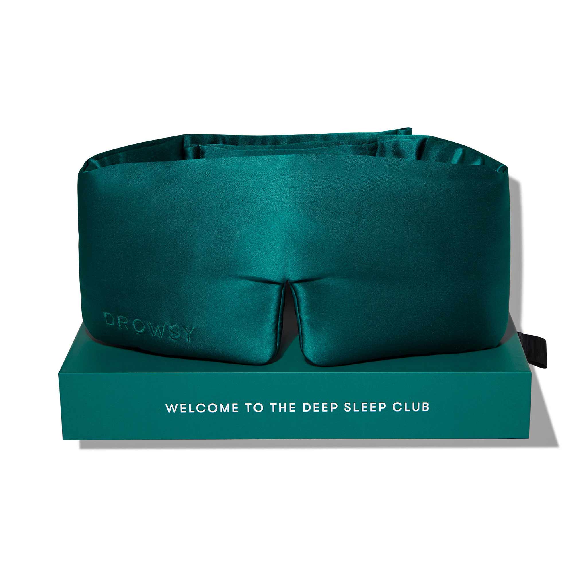 Green Sapphire by us.drowsysleepco is a luxurious teal silk eye mask embroidered with DROWSY, presented in a matching box with WELCOME TO THE DEEP SLEEP CLUB—ideal for beauty sleep and improved skin hydration.