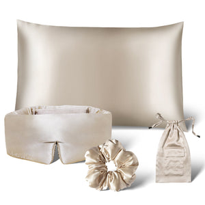The us.drowsysleepco Sensual Sleep Bundle in Dusty Gold includes a silk pillowcase, sleep mask, scrunchie, and drawstring pouch—luxurious beige accessories displayed on a white background.