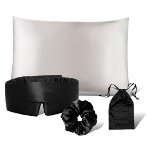 The drowsysleepco Drowsy is the New Black Bundle + Akoya features a white silk pillowcase, black padded sleep mask, black satin scrunchie, and small black drawstring pouch, all from the Beauty Sleep Collection, shown on a white background.