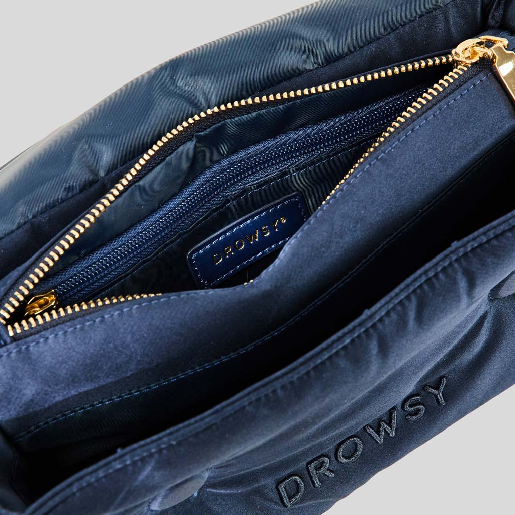 Close-up of the Drowsy Silk Necessaire in Midnight Blue, featuring a gold zipper, inner zip pocket, and DROWSY fabric label—an elegant pouch to elevate your beauty routine.