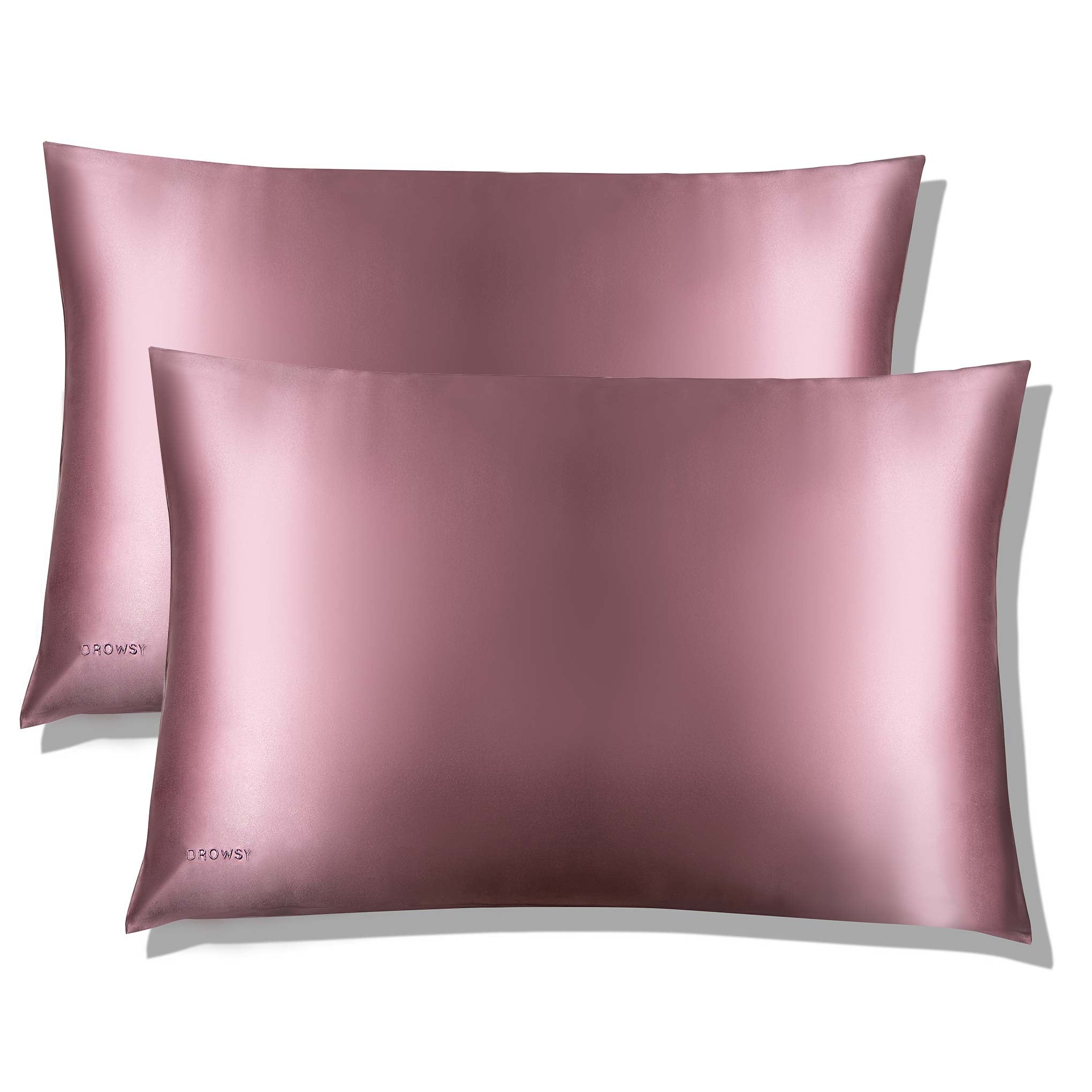 Two smooth, shiny Damask Rose Silk Pillowcases by us.drowsysleepco are stacked with one slightly overlapping the other. Each features a subtle logo in the bottom left corner, perfect for hair protection and skincare. The background is plain white.
