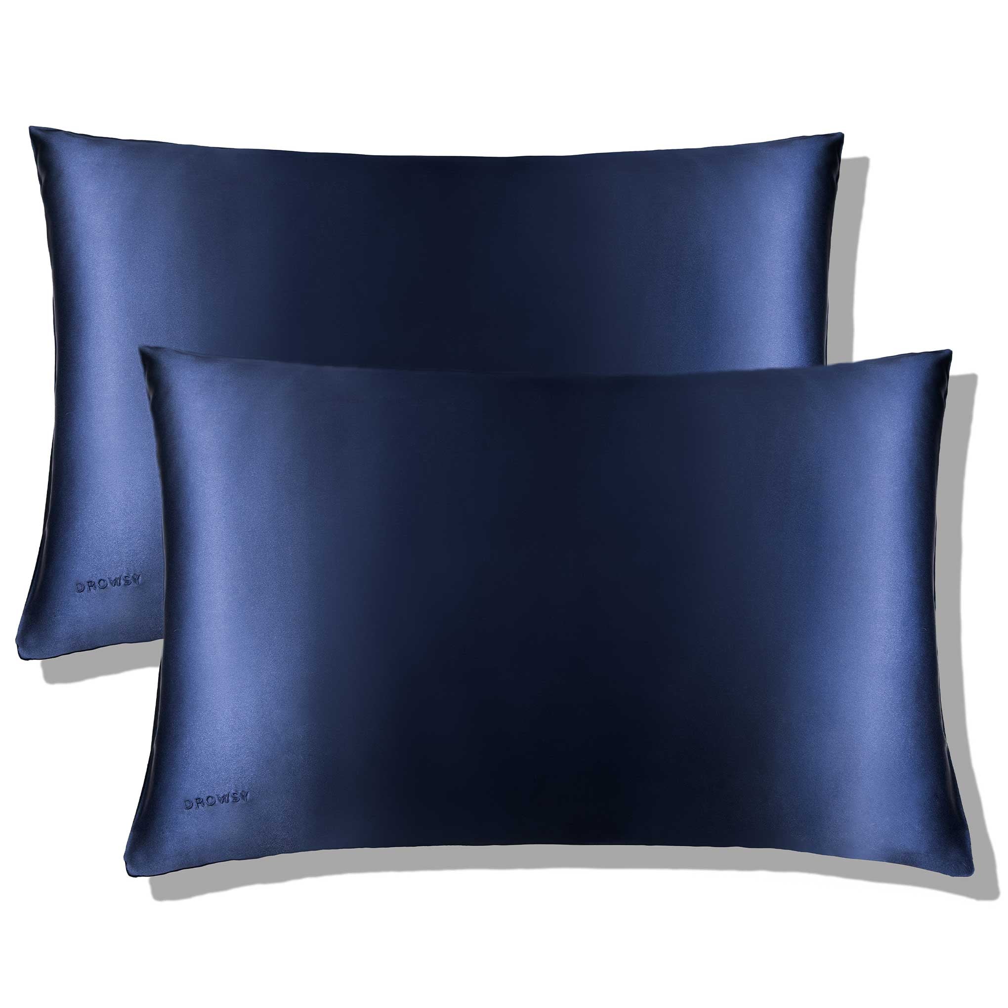 The Midnight Blue Silk Pillowcase by us.drowsysleepco features a smooth, shiny finish with subtle DROWSY embroidery—an ideal nightly essential for hair protection and skincare, shown in overlapping pairs on a white background.