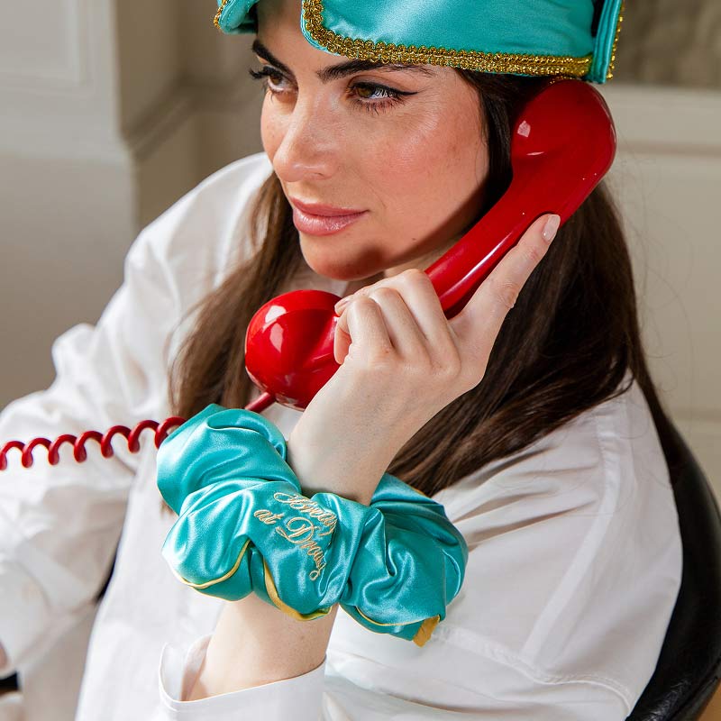 Wearing a turquoise 