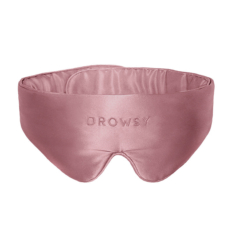 Introducing the Featherweight Silk Eye Mask Damask Rose by us.drowsysleepco—a pink eye mask expertly crafted from luxurious mulberry silk, featuring the DROWSY logo elegantly embroidered on the front.