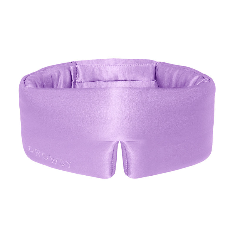 Lavender coloured silk sleep mask on white background