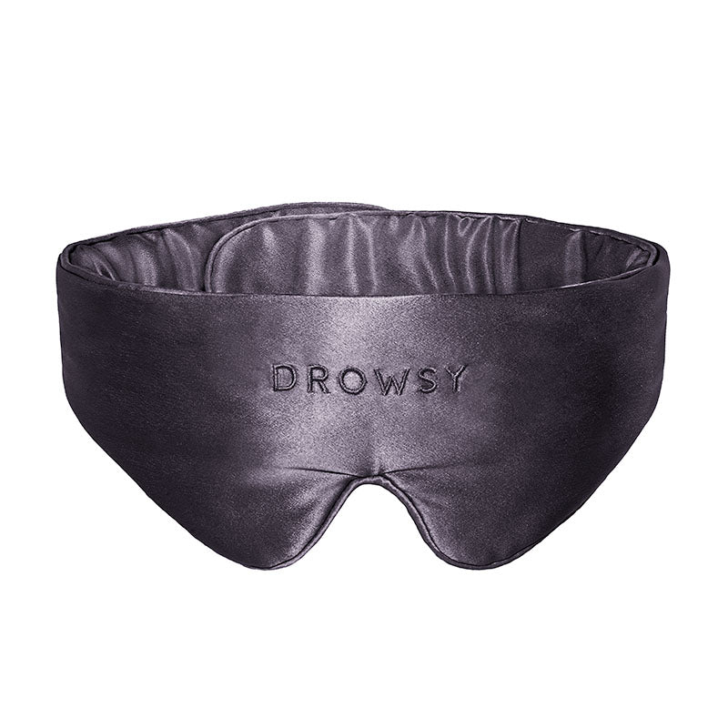 A Featherweight Silk Eye Mask Moonlight Shadow by us.drowsysleepco in black, featuring “DROWSY” embroidered in capital letters on the front.