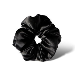 The Black Jade - Padded Scrunchie by us.drowsysleepco, an oversized shiny black silk hair accessory, is shown in a circular shape on a white background with a subtle shadow.